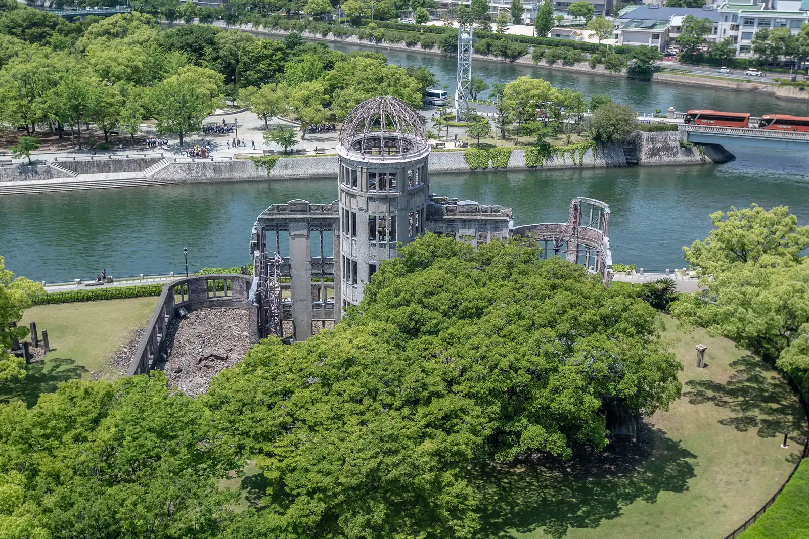 The Atomic Bomb Dome seen from above on the Orizuru Tower roof, with the river and the trees of Peace Memorial Park beyond