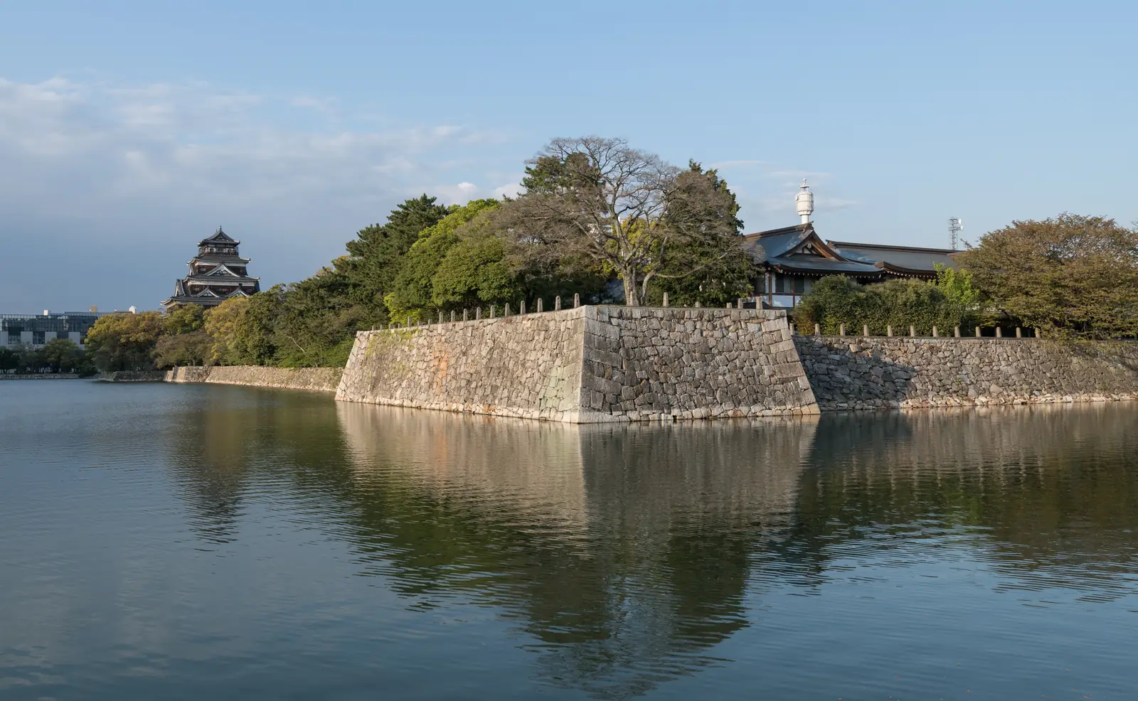 Hiroshima Castle's five-storey keep above its stone walls and the west moat
