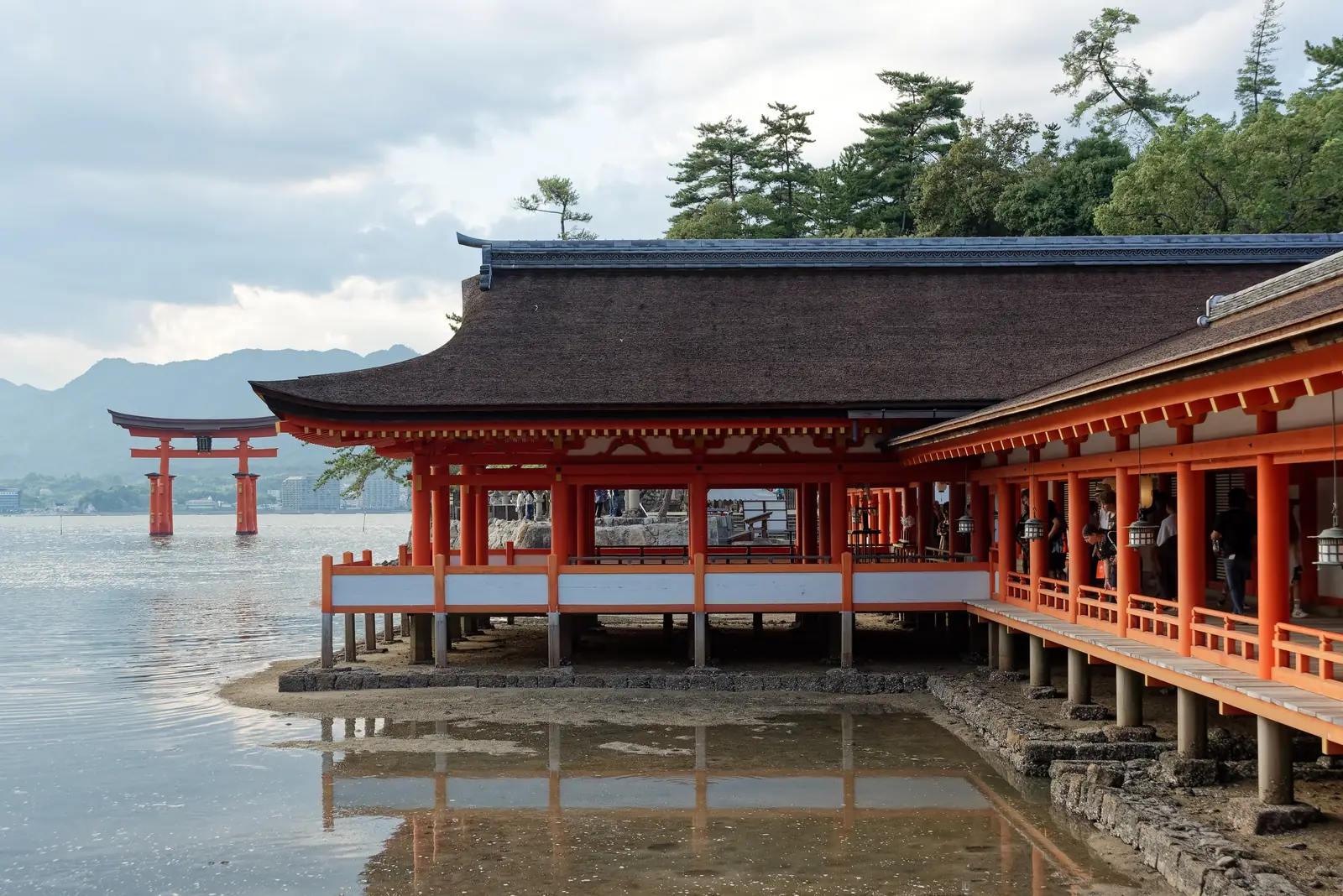 Itsukushima Shrine's halls over the water with the great torii beyond in the bay
