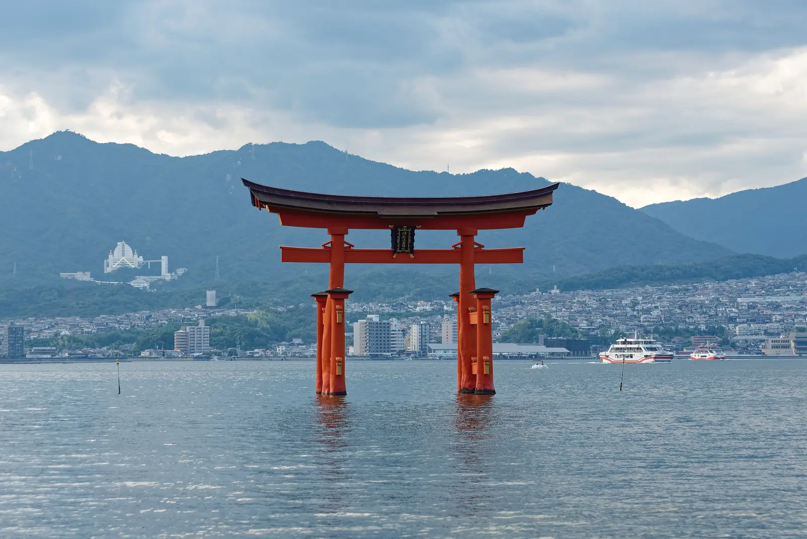 The great vermilion torii of Itsukushima Shrine standing in the sea at high tide