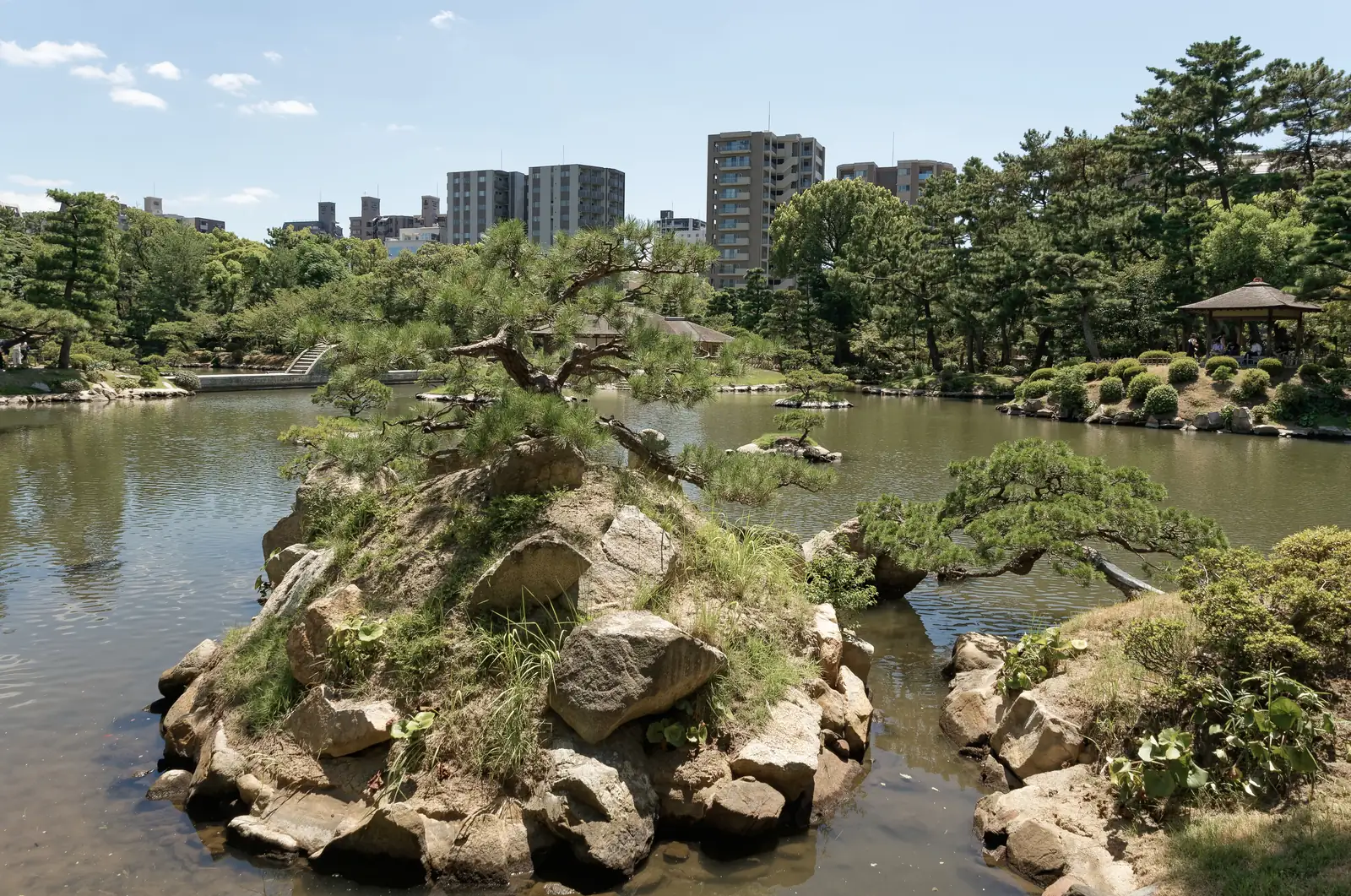 Shukkeien Garden's central pond with small pine-covered islands